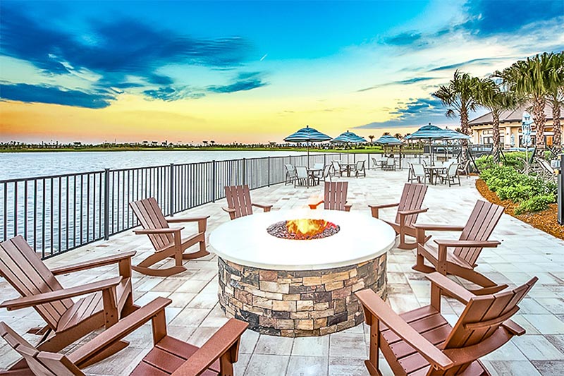 A fire pit along water in a community at Lakewood Ranch