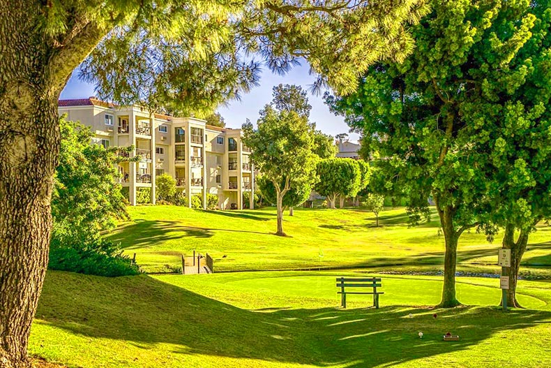 Photo of an apartment complex overlooking a golf course in the Laguna Woods Village 55+ community in Laguna Woods, California