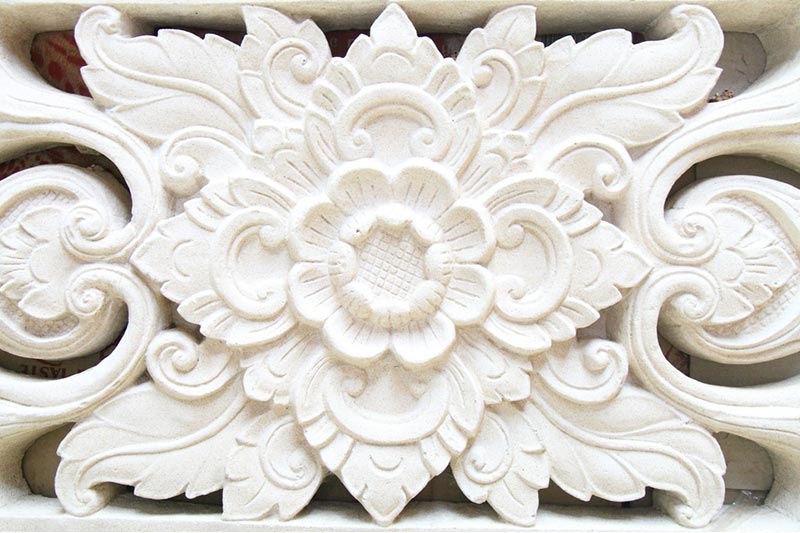 Intricate white stucco design in shape of flower