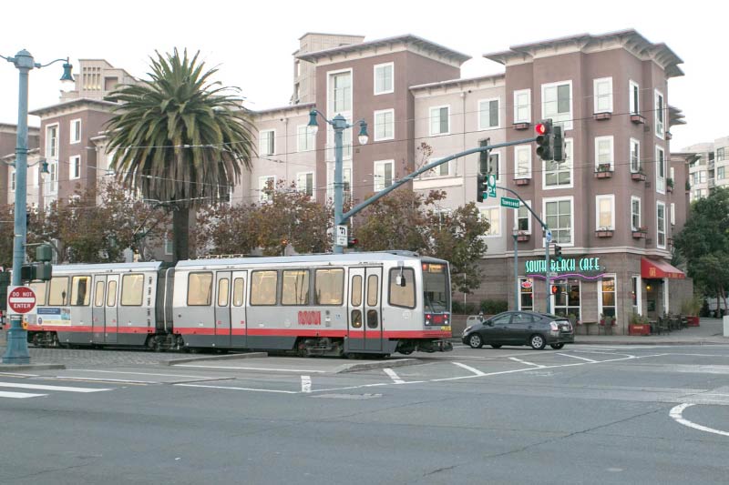 A street car driving through an intersection in South Beach. 