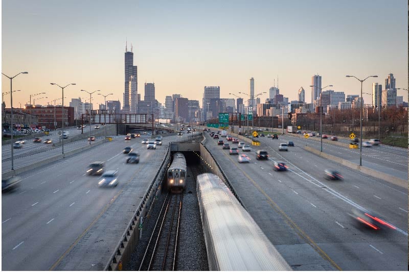 The CTA Red Line emerges from a tunnel under the Dan Ryan Expressway in Chicago.