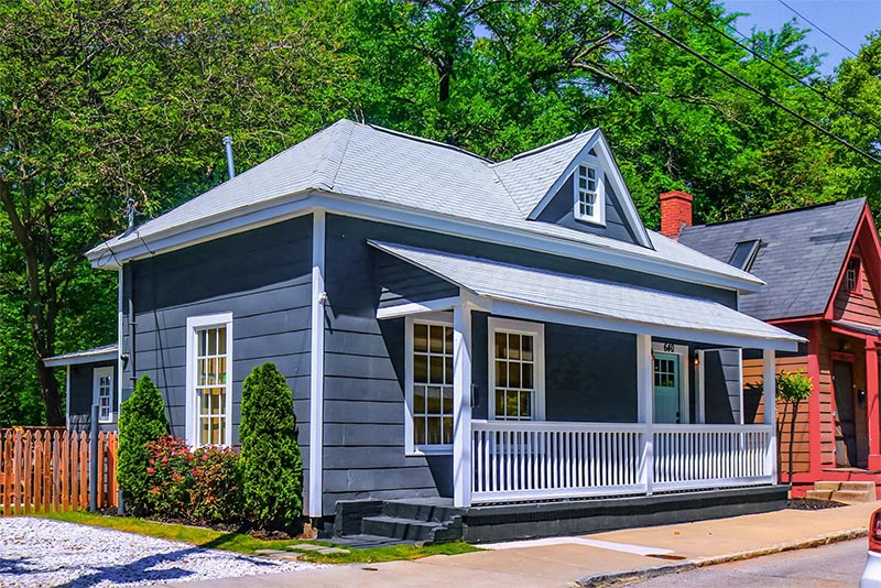 A small blue house with a white balcony in Cabbagetown Atlanta