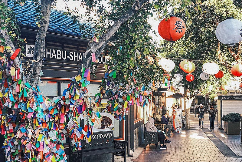 The Little Tokyo neighborhood in Los Angeles with people walking by a wishing tree