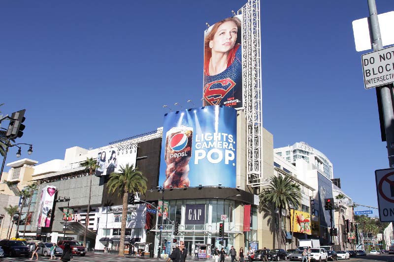Advertisements line a storefront in Hollywood