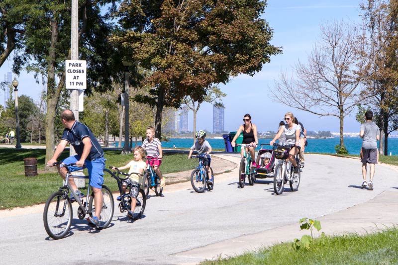 People biking along the lakefront trail near the 31st St. Beach. 