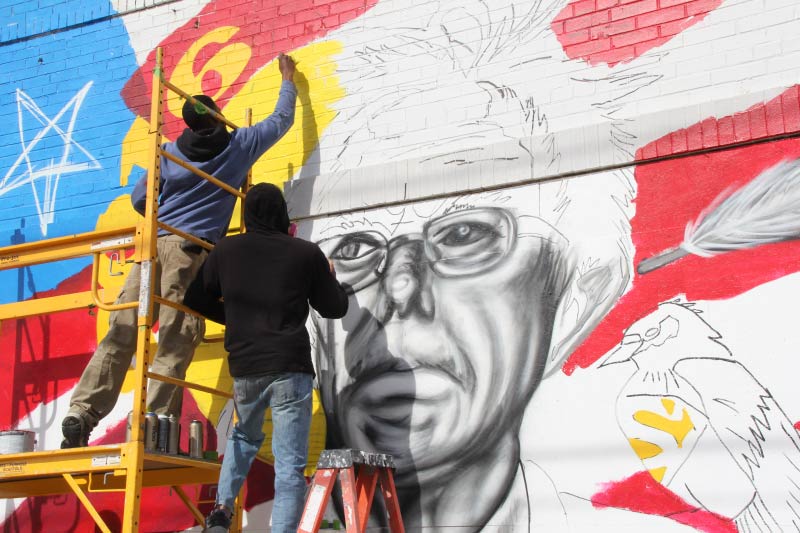 People painting a mural in Richmond's Museum District. 