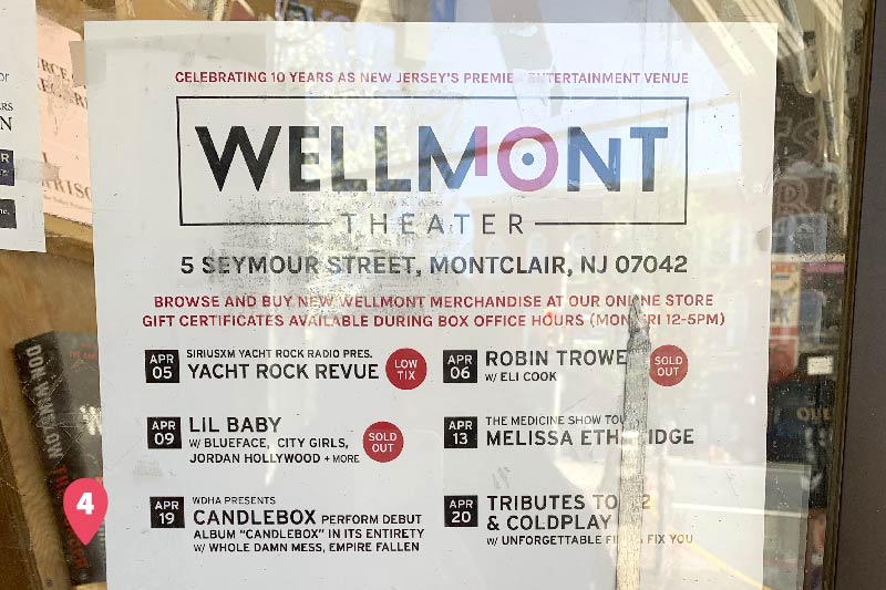 A sign on the front door of the Wellmontt Theater detailing upcoming shows. 