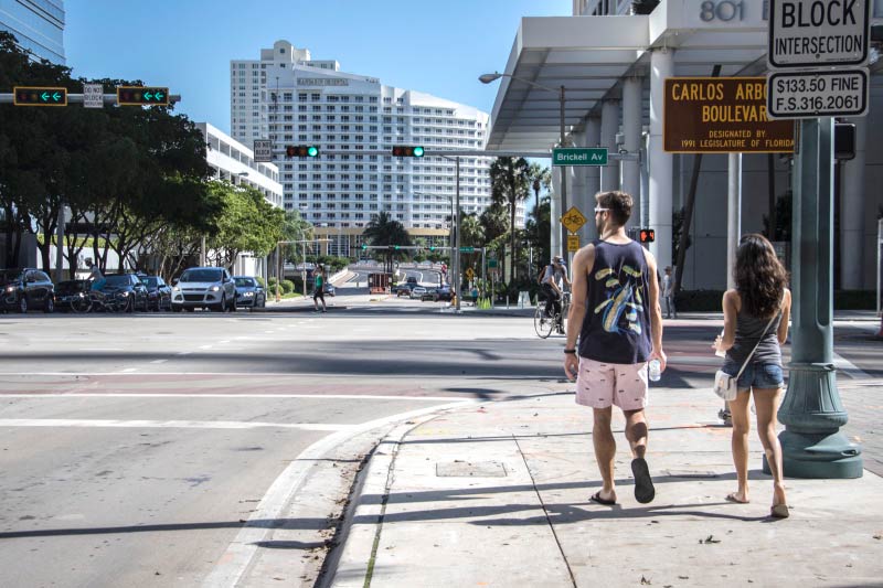 People walking along the sidewalk in Brickell, Miami. 