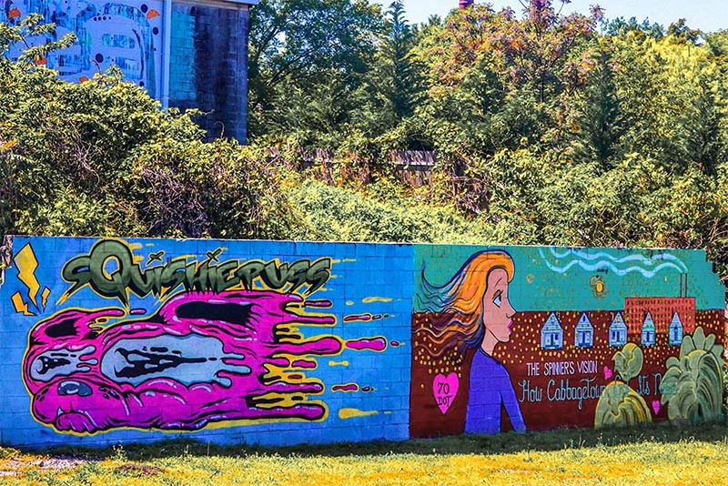 A two-panel mural on a small wall in Cabbagetown Atlanta