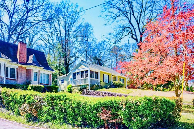 Suburban home in shaded residential street.