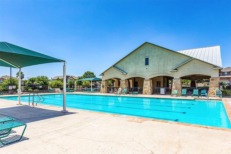 A pool and poolhouse in the Alamo Ranch community in Texas