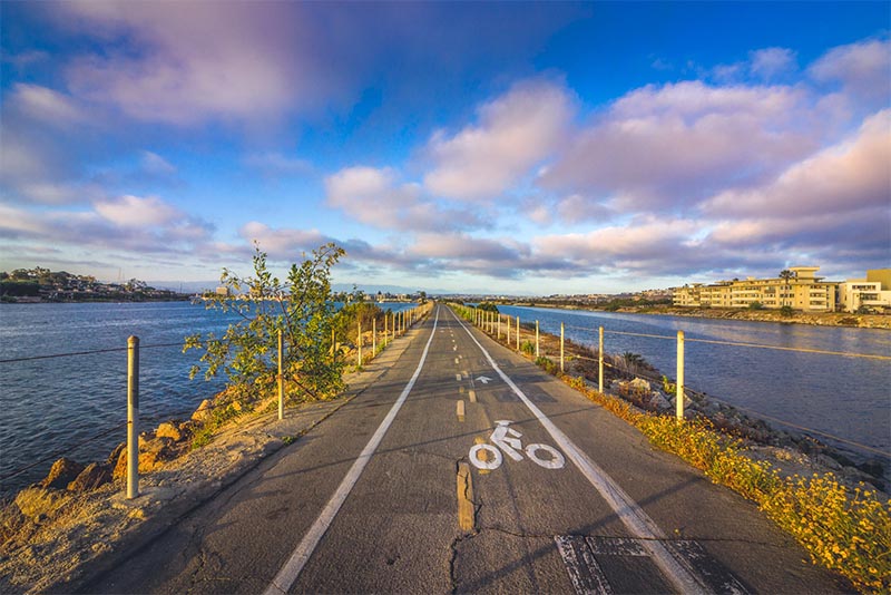 Ballona Creek Trail bike path straight ahead with the creek on either side in Los Angeles