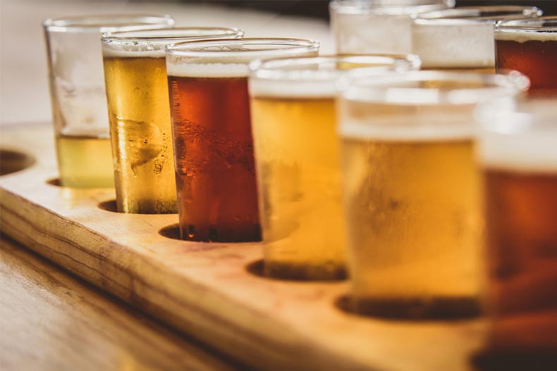 A flight of beers on a wooden board
