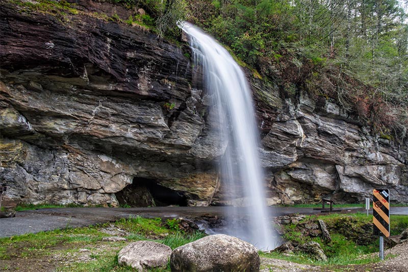 A waterfall falls into a basin where you can walk underneath in the Charlotte area