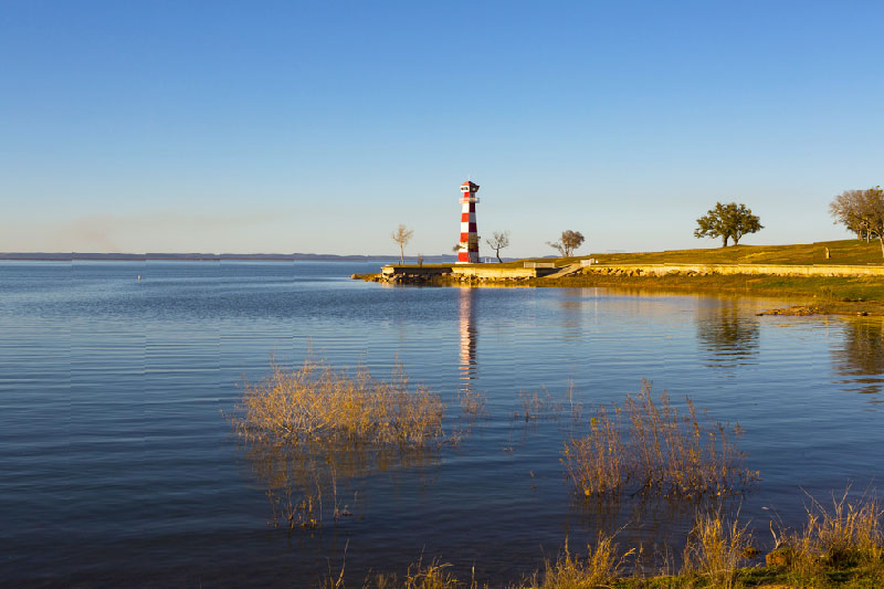Red and white lighthouse along Lake Buchanan in Texas