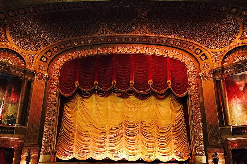 Inside of Byrd Theater looking at stage with curtain.