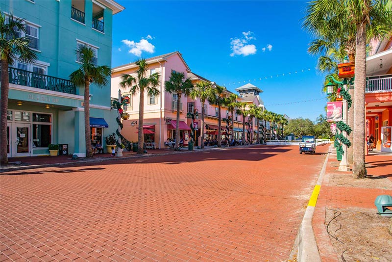 Colorful homes and businesses along red rick paved street in Celebration, FL.