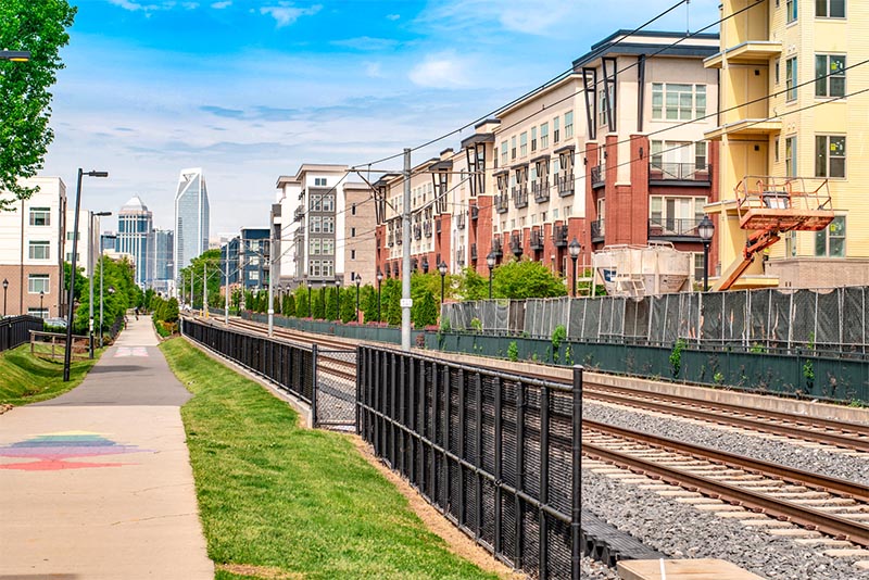 The Charlotte Rail Trail next to the Light Rail tracks with buildings behind