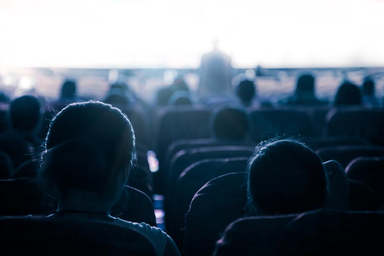 People seated in a dark theater