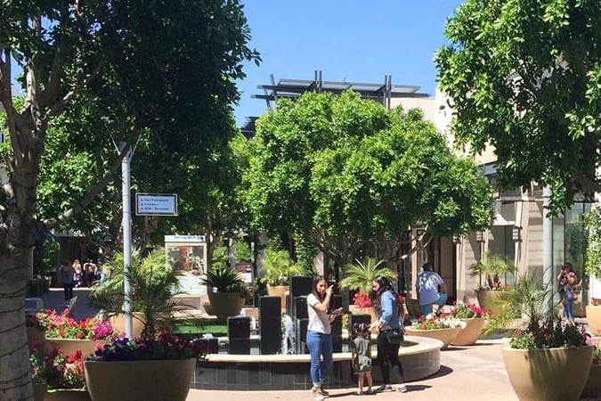 Families walking around a lush plaza in Coronado, AZ