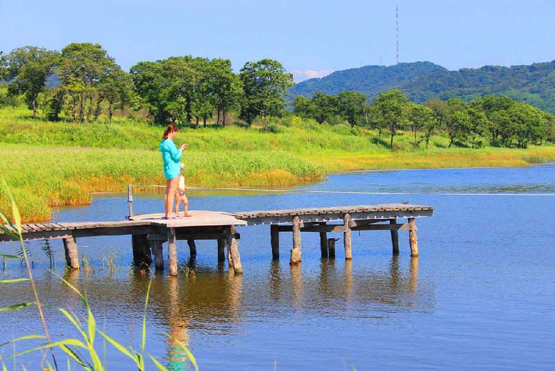 Mother and daughter out on fishing pier at LAke Cypress Springs in Texas.