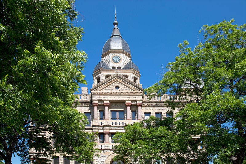 The top dome of the Denton County Courthouse in Dallas with its gray stone.