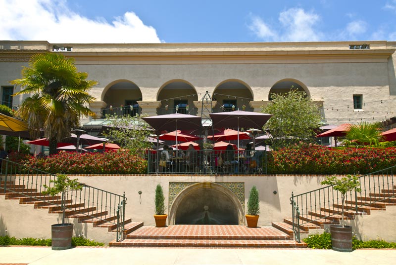 Exterior of large building with outdoor patio dining.