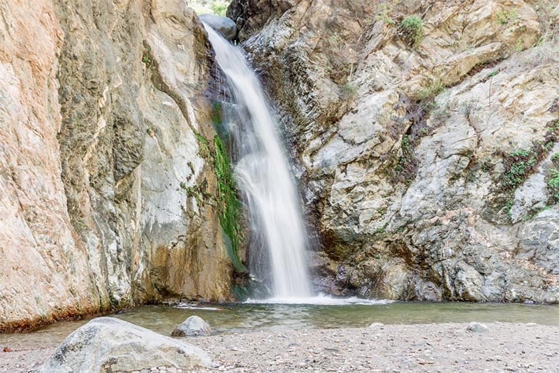 An image of Eaton Canyon waterfall, with the tall falls running over a canyon
