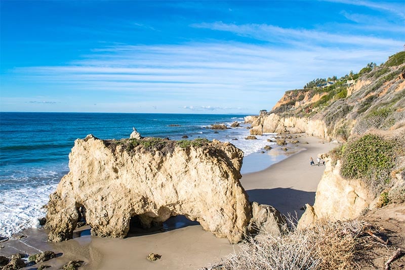 Large rock formations run along the beach in Los Angeles