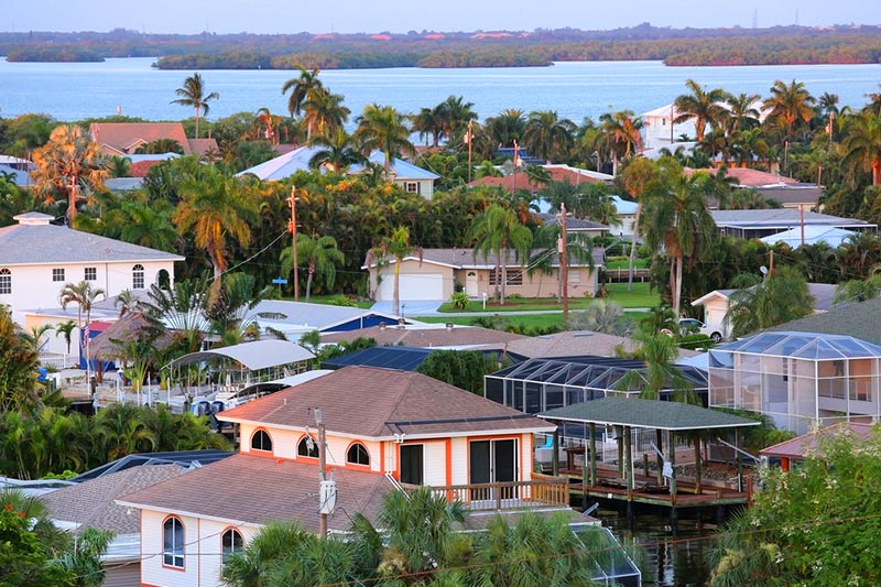 Palm trees and homes beside the water in Fort Myers, Florida