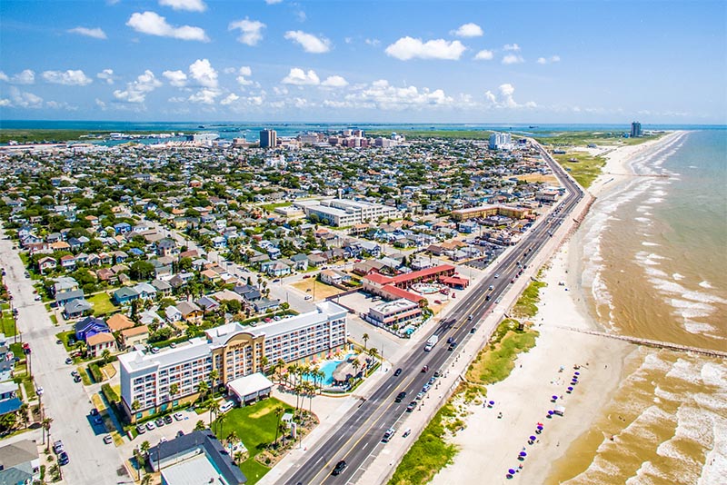 An aerial view of the Galveston beach area with many buildings and beaches visible from the air