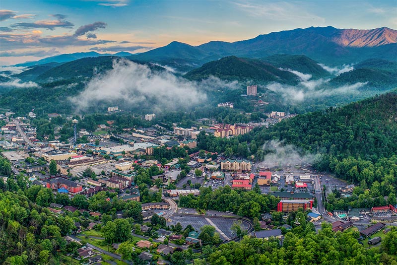 A sweeping shot of Gatlinburg as it sits in a valley between the Smoky Mountains in the background