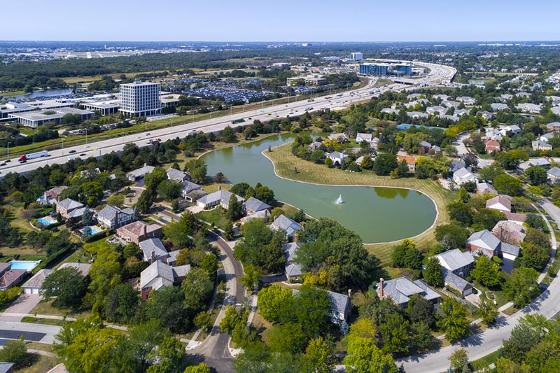 aerial picture of green community with homes and pond in Glenview, IL