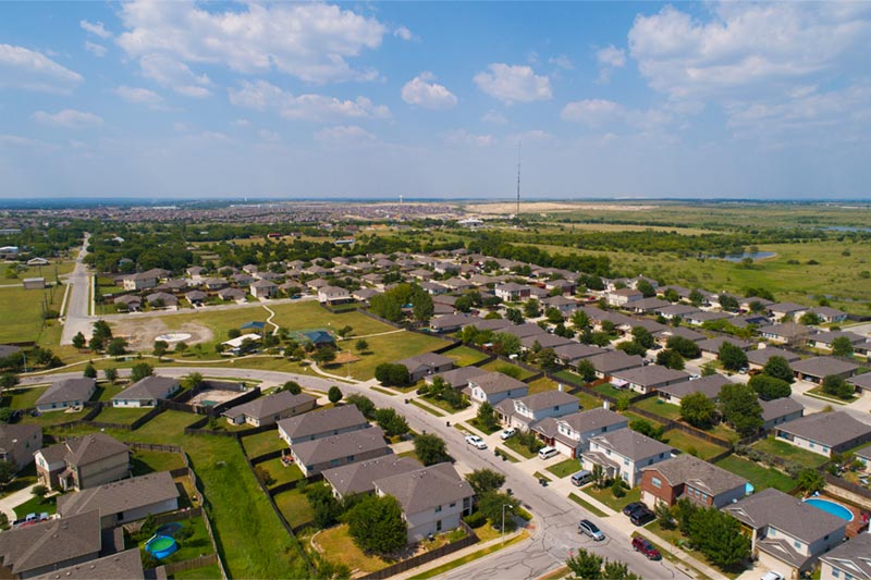 aerial photo of neighborhood with homes and green space