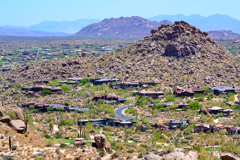 Aerial view of Scottsdale with large mountain in background.