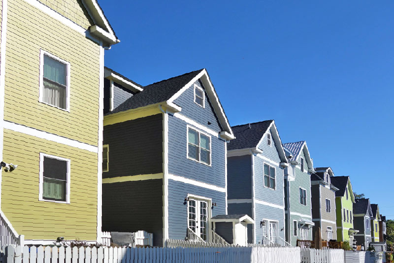 Row of colorful two story homes.