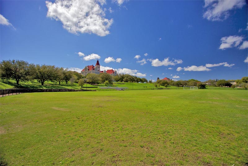 huge lawn in front of trees and st edwards university in texas