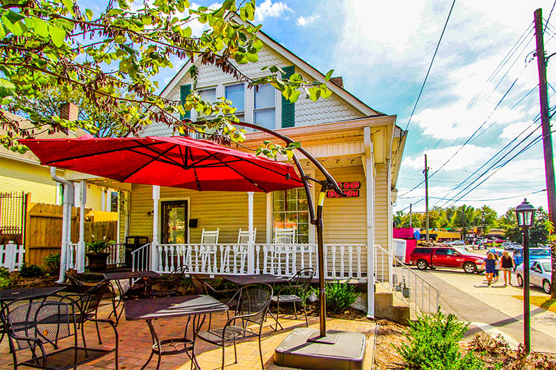 An umbrella over tables and chairs in East Nashville