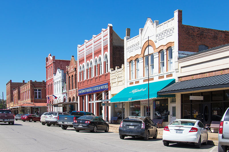 Cars parked outside buildings in the downtown area of Lockhart, Texas