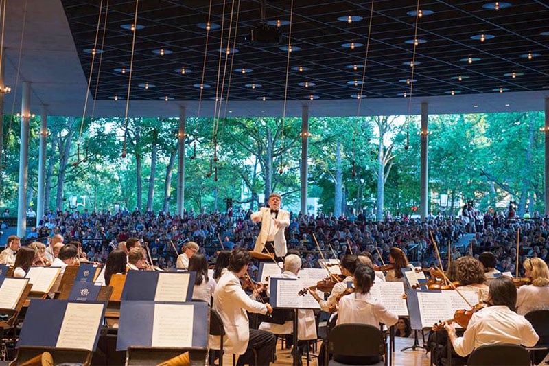 A conductor directing an orchestra at Ravinia in Highland Park, Illinois