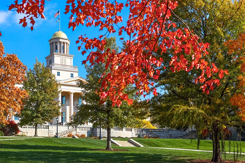 The Iowa state Capitol Building in Iowa City surrounded by autumn foliage
