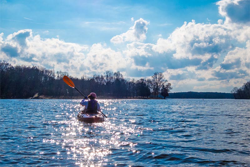 Woman on kayak in the middle of Old Hickory Lake on a sunny day