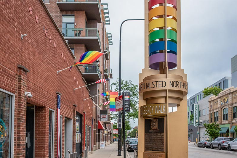 Rainbow flags and rainbow street lamps line the streets of Boystown Chicago