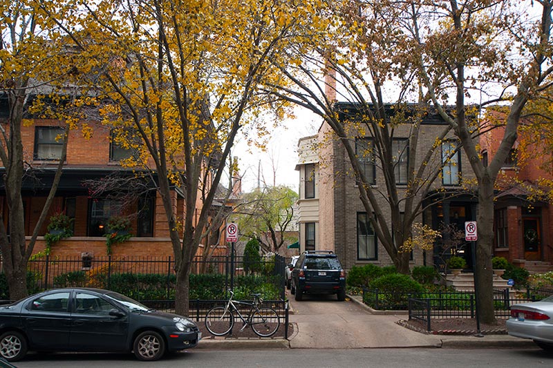 Two brick homes along tree-lined street in Lakeview neighborhood of Chicago