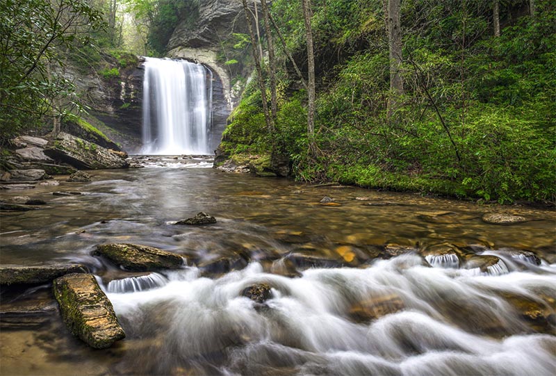 A short waterfall flows into a river in the Charlotte area, North Carolina