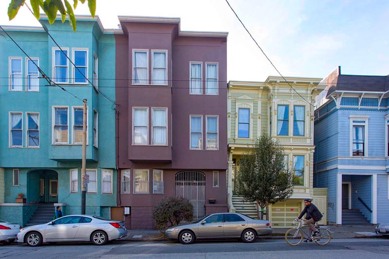 colorful neighborhood homes in a line along street