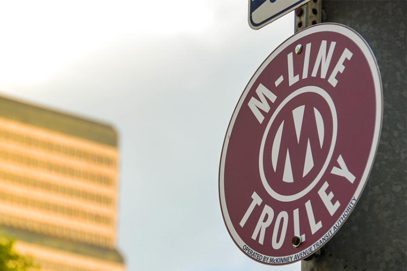 Close up view of a sign for the McKinney Avenue trolley system in Dallas, Texas