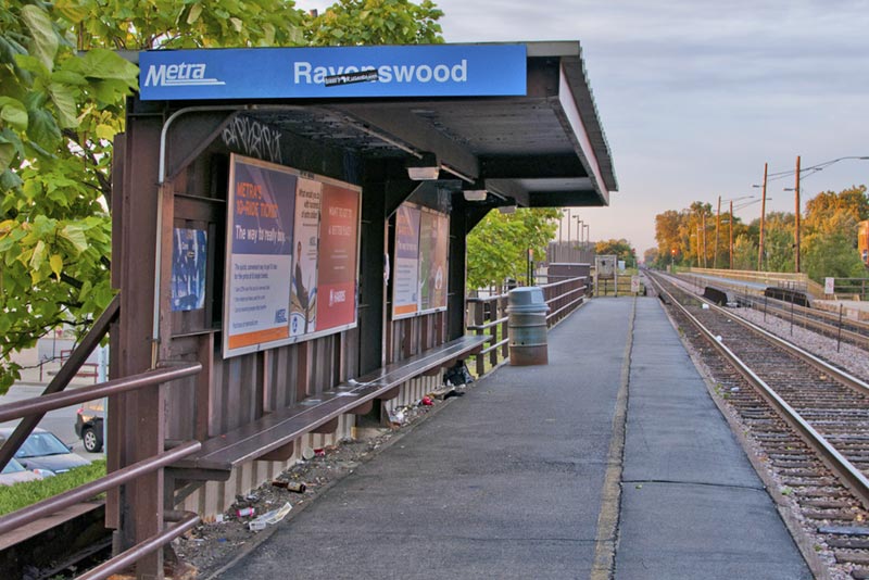 Ravenswood train stop with benches and train tracks.