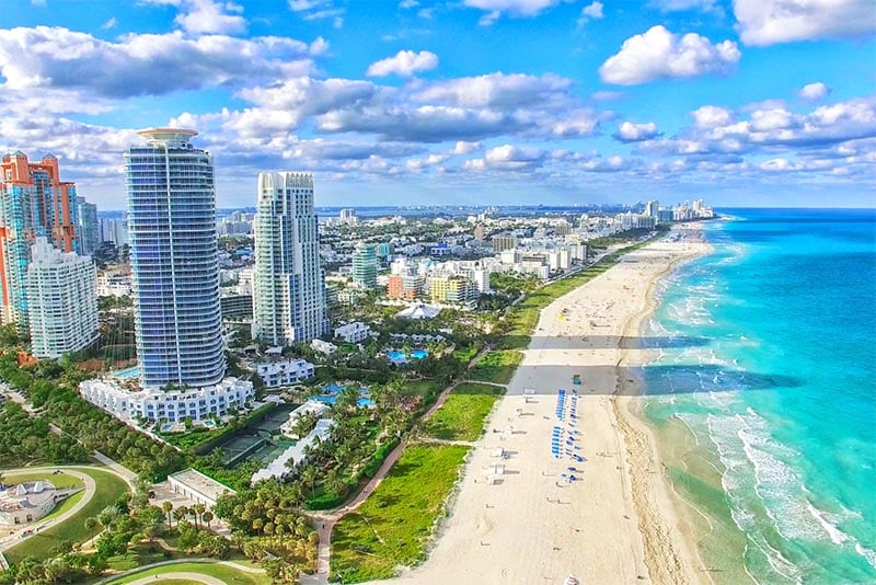 An aerial view of Miami Beach Florida with tall buildings in the foreground