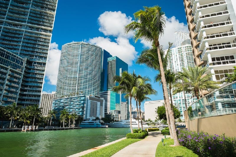 Tall condo buildings in Downtown Miami along waterway.